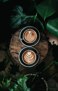 high angle photo of two green mugs filled with coffee