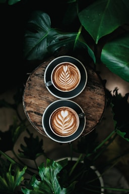 high angle photo of two green mugs filled with coffee