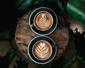 high angle photo of two green mugs filled with coffee