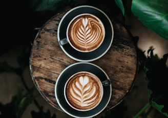 high angle photo of two green mugs filled with coffee