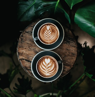 high angle photo of two green mugs filled with coffee