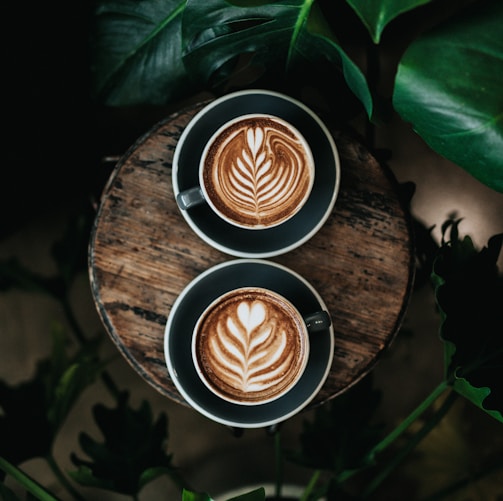 high angle photo of two green mugs filled with coffee