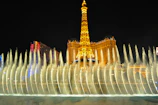 The mesmerizing Bellagio fountains erupting in a choreographed water show under the night sky