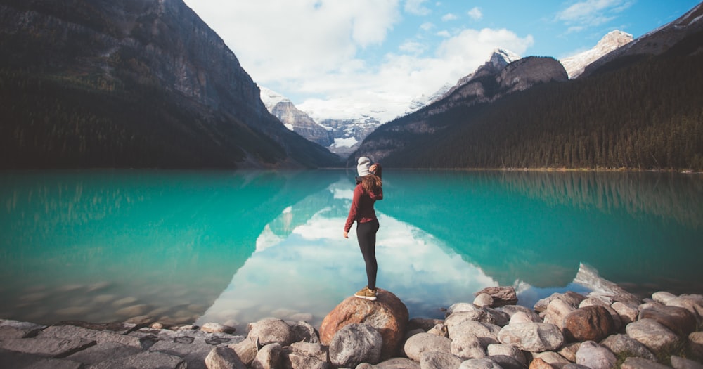 woman standing on brown rock taken at daytime