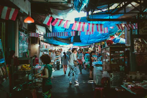 A lively local market scene bustling with colorful stalls and friendly vendors.