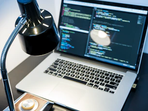 A sleek workspace showing a laptop screen with AI writing software in use.