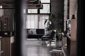 Interior shot of a trendy, open-concept living room featuring black and gold decor elements.