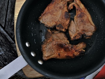 three fried meats on cast iron skillet