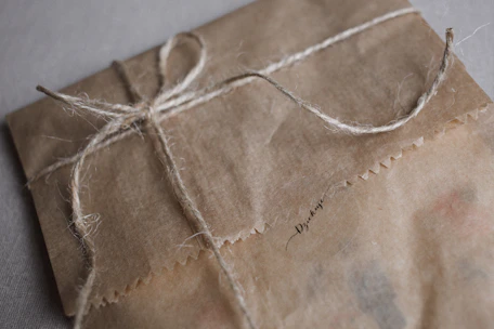 Artisan packaging of organic Ceylon spices with natural brown paper and yellow twine.