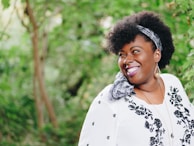 smiling woman looking on right side during daytime