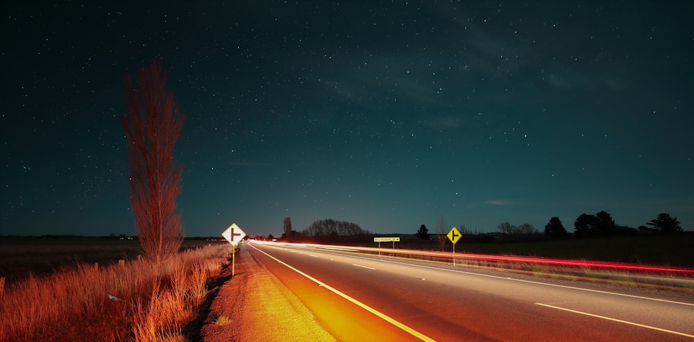 time lapse photography of car running on road