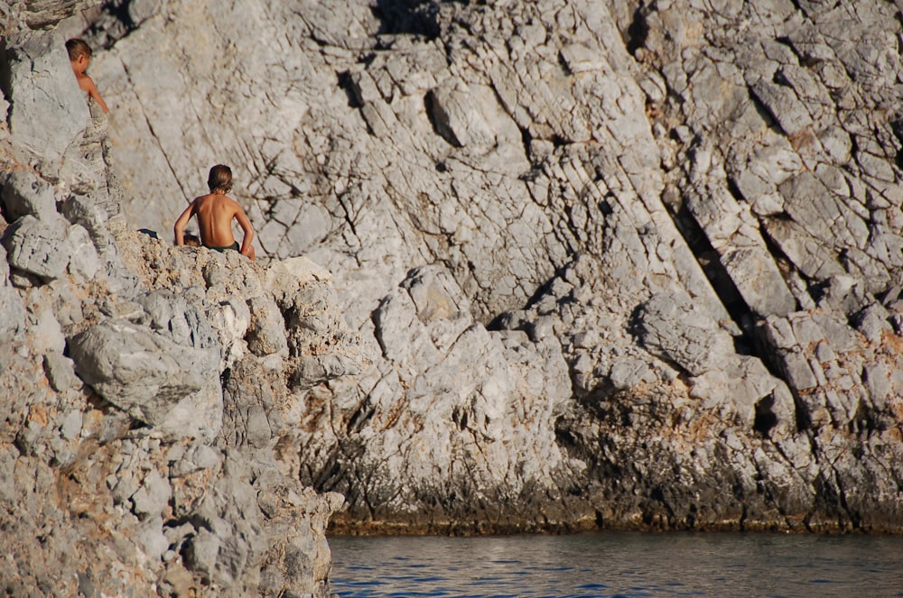 person sitting on cliff