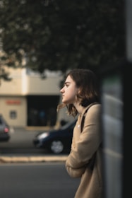 A person pausing thoughtfully in a busy city street, embodying awareness amidst everyday life.