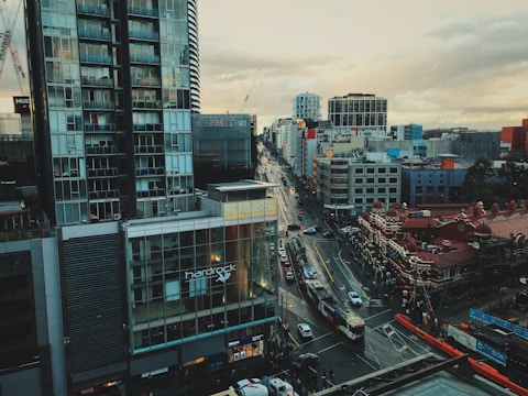 A cityscape featuring modern public transportation vehicles moving along urban streets.