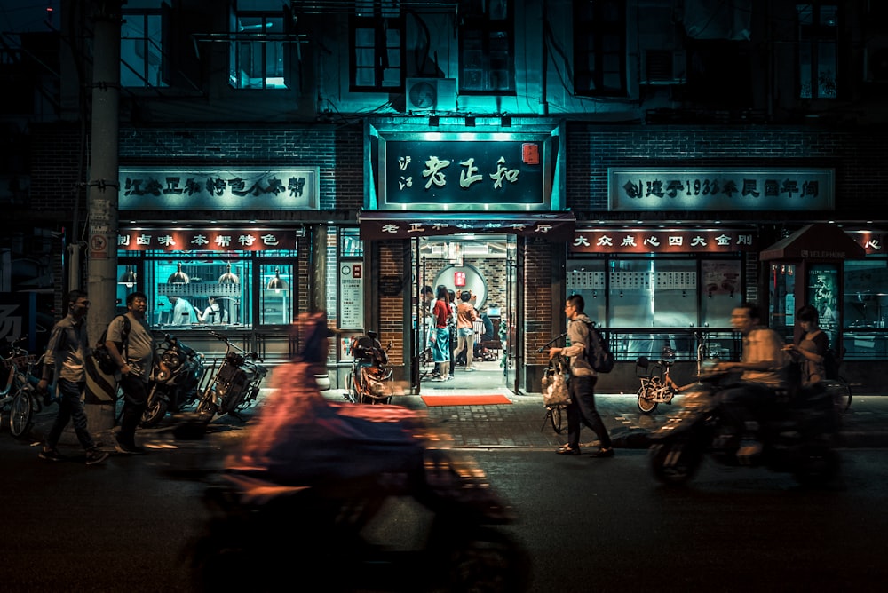 motorcycles and people passing by at night time