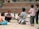 A diverse group of students engaged in a lively discussion outdoors.