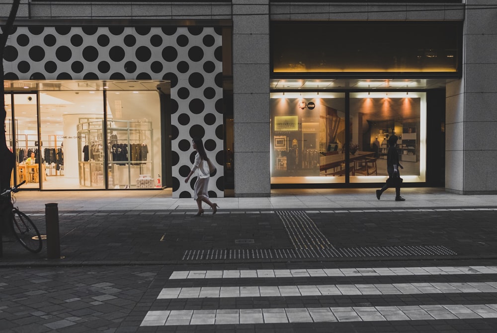 two women walking beside store