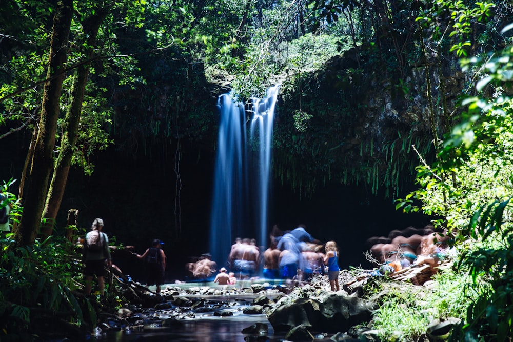 people near waterfalls during daytime