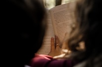 a woman reading a book in the dark
