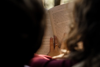 a woman reading a book in the dark