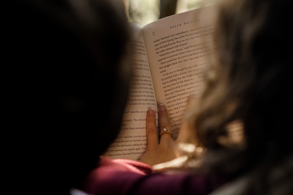 a woman reading a book in the dark