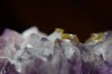 Close-up of a glowing amethyst crystal pulsating with cosmic energy.