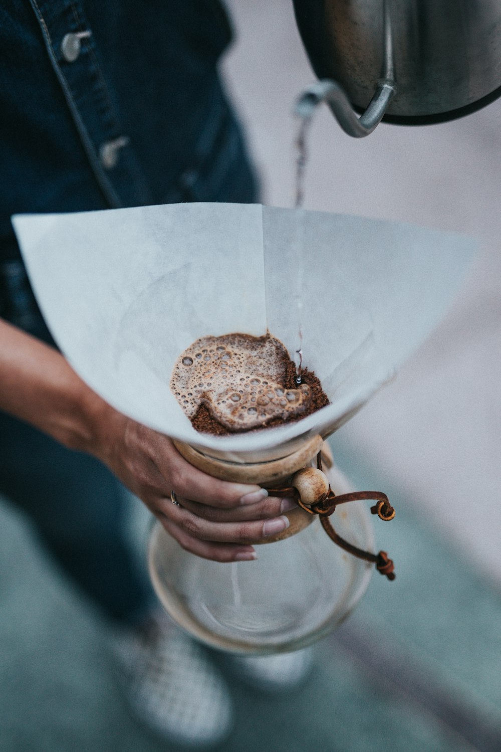 person holding clear glass pitcher