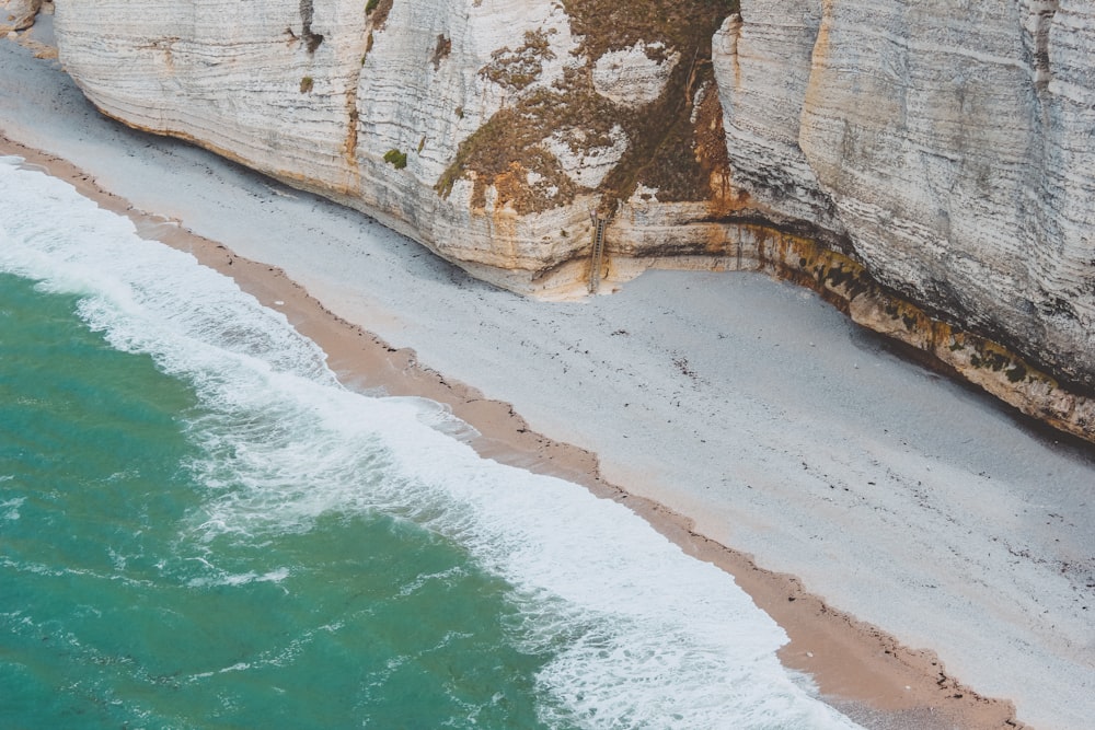 bird's eye view photo of seashore beside cliff