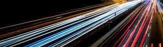 time-lapse photography of cars passing through the road during night time