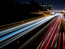 time-lapse photography of cars passing through the road during night time
