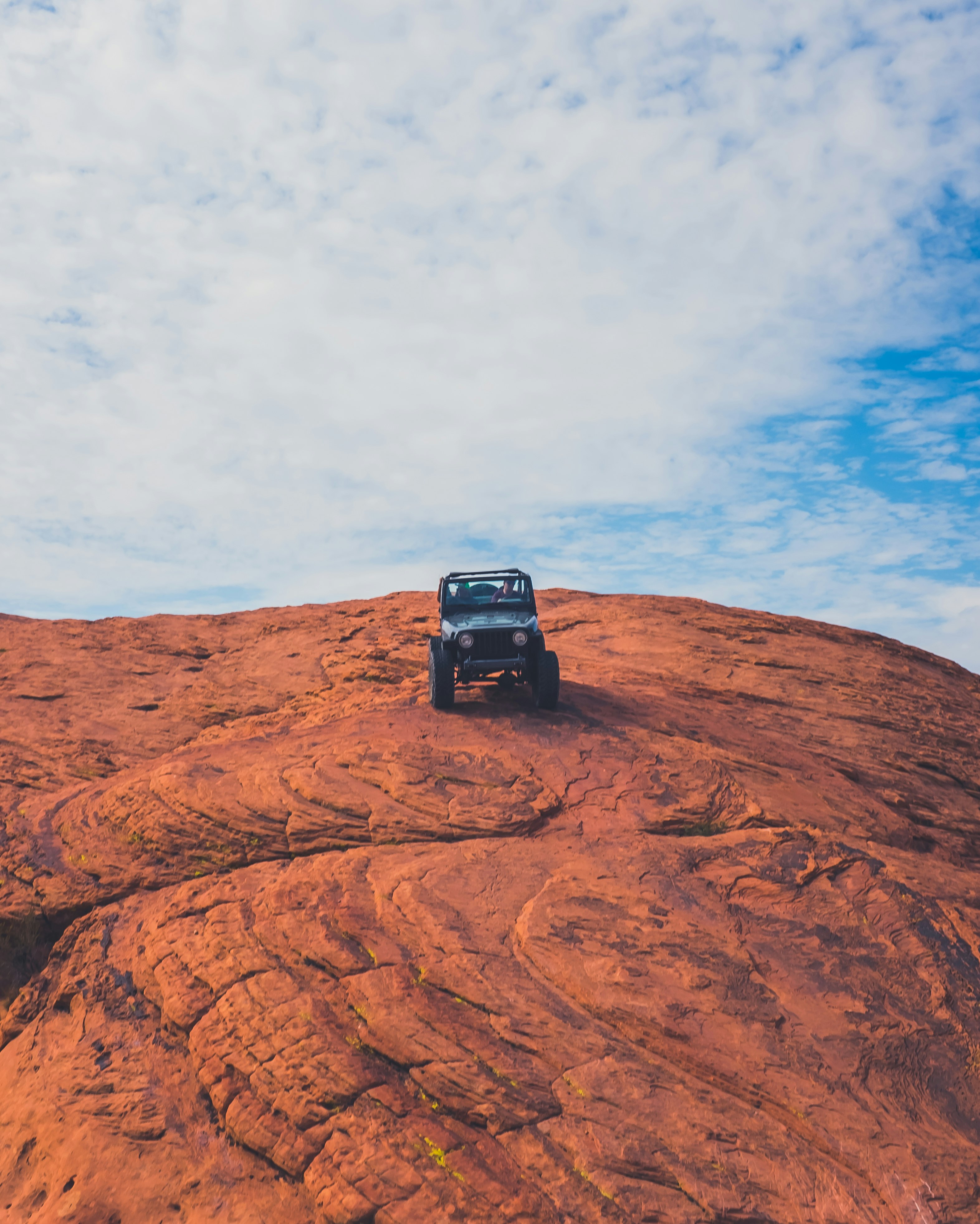 Jeep SUV on top of rock