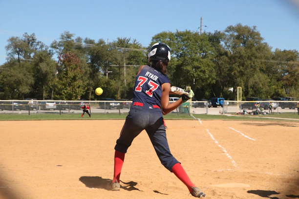 An athlete wearing a custom softball uniform during a game.