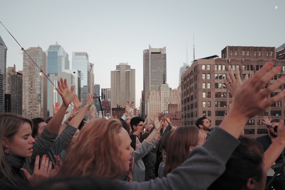 group of people waving their hands