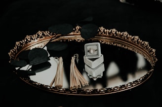 brown tassel earrings on top of glass engagement tray