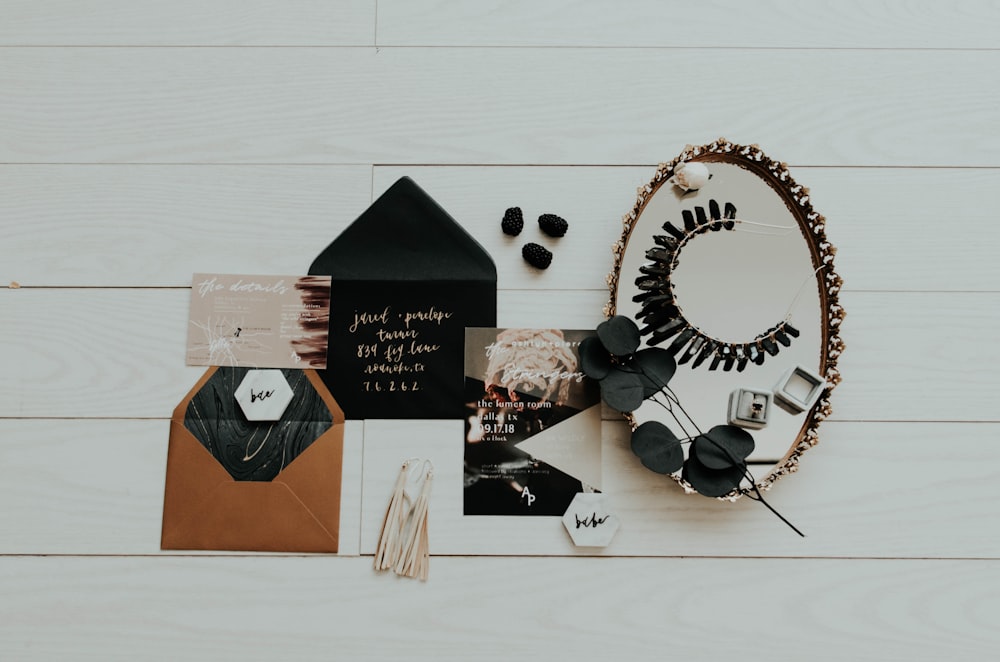 flat lay photography of mirror and envelopes