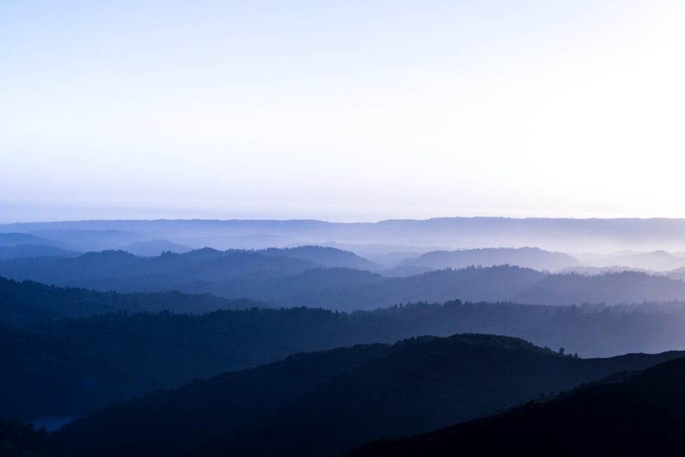 mountains covered with fog during daytime