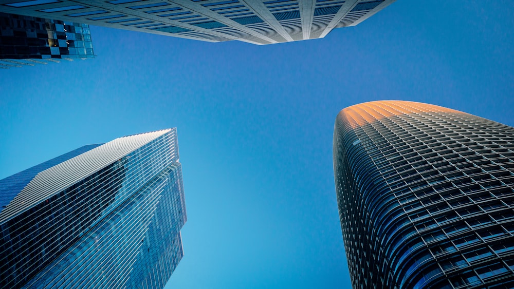 looking up at two tall skyscrapers in a city