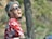 A person wearing a colorful, funny graphic t-shirt while laughing with friends outdoors.