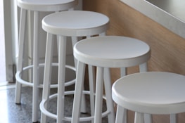 Comfortable saddle bar stools arranged around a kitchen counter.