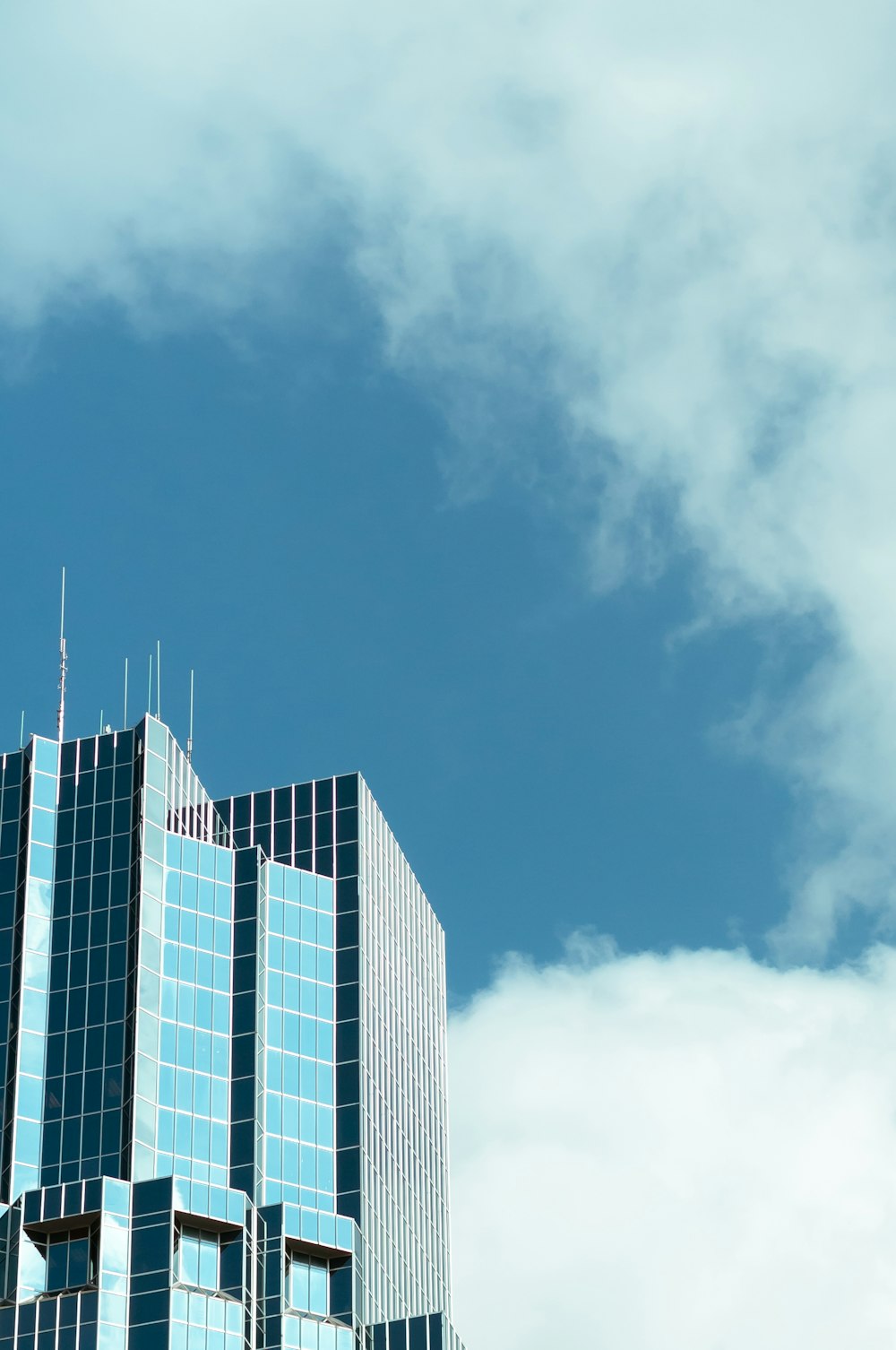 clear glass wall highrise building under clear sky during daytime