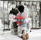 Children and parents happily working together on an educational puzzle at home.