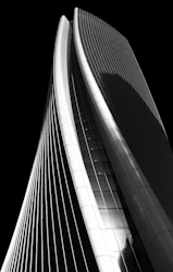 high-rise curtained wall building grayscale photography