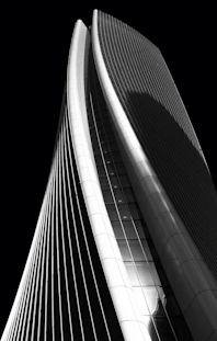 high-rise curtained wall building grayscale photography