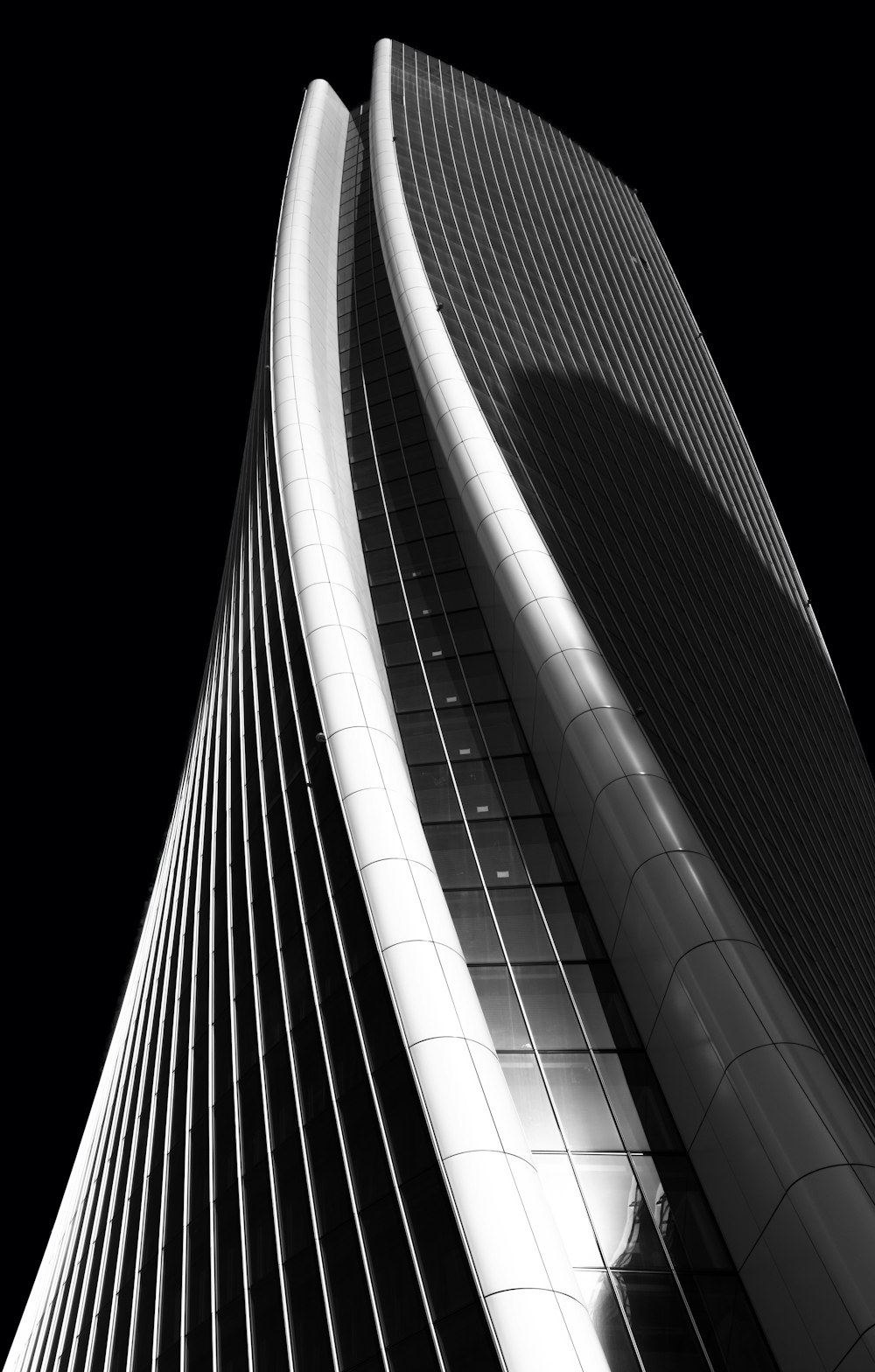 high-rise curtained wall building grayscale photography