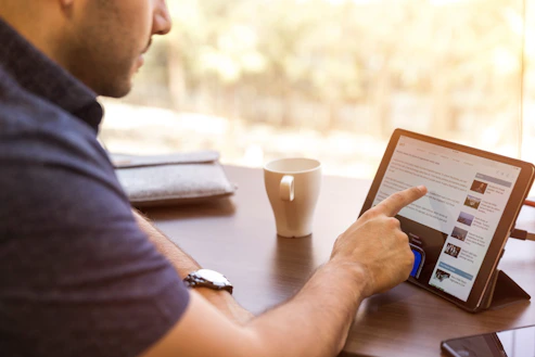 man reading article on tablet