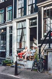 two person sitting in front of door