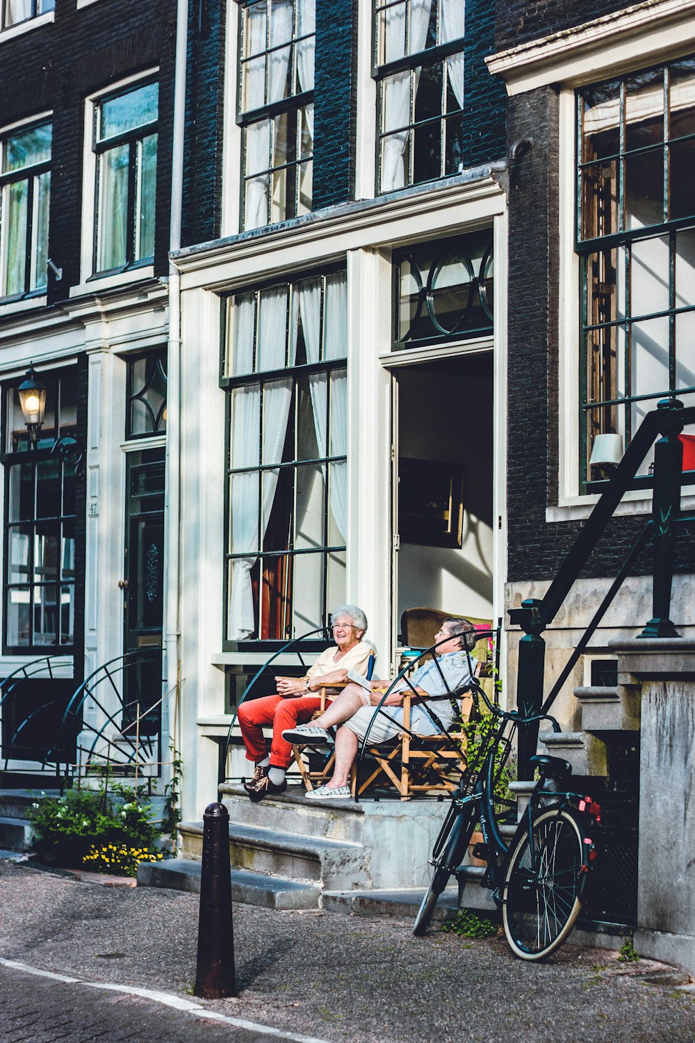 two person sitting in front of door