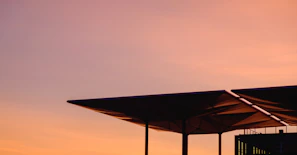 Sunset view highlighting the clean lines and sturdy construction of a recently completed roof.