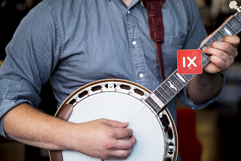 man playing banjo guitar