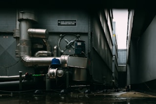 a large metal pipe next to a building